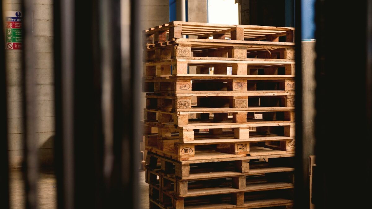 selective focus photography of piled brown wooden pallets