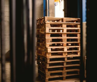 selective focus photography of piled brown wooden pallets