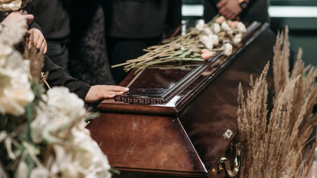 A Person Holding a Wooden Coffin