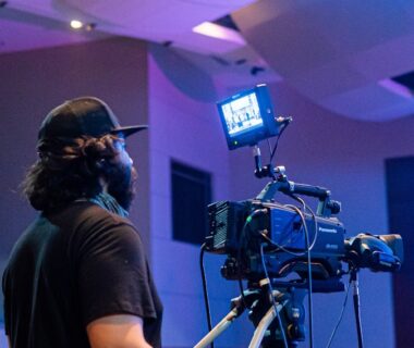 Professional videographer shooting stage during concert