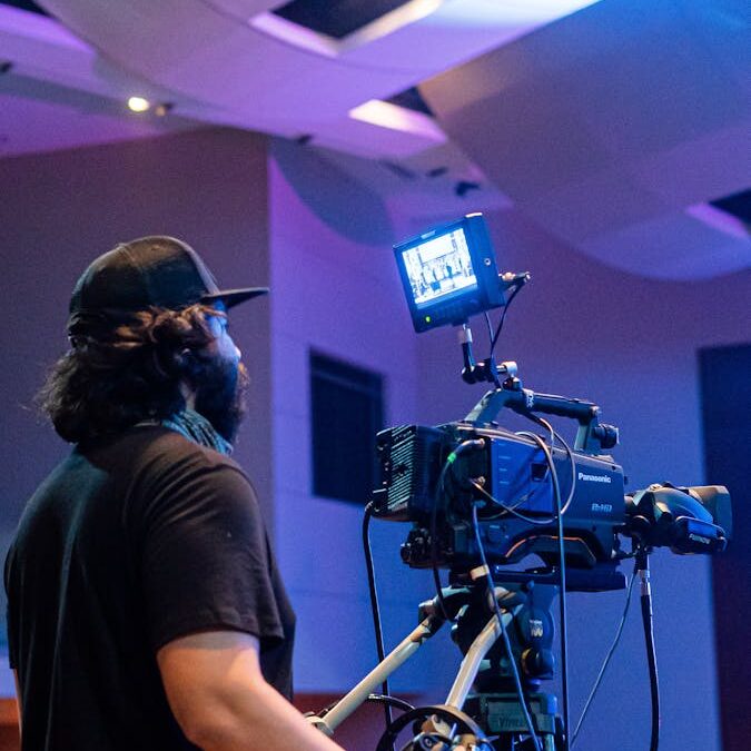 Professional videographer shooting stage during concert